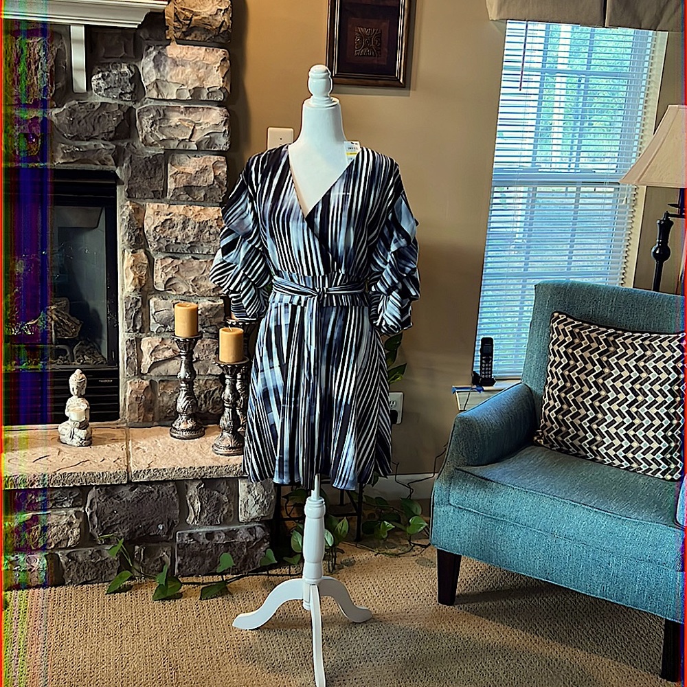 This dress is above the knees. Ruched sleeves. Navy blue and is 100% polyester.